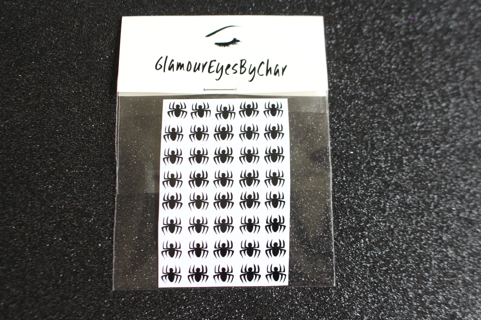 Spider Halloween Nail Stickers – 40 Pieces
Part of our Halloween Collection, these creepy-cute spider nail stickers are the perfect way to get spooky without a trip to the salon. Apply them to natural or acrylic nails, or layer over regular polish, gel, or shellac for an instant Halloween vibe.
Each pack includes 40 stickers — just right for nail art 💅🏾 or fun DIY projects 🕷️.
🌟 Glam Tip: Apply some of our glitter on your nails to really GLAMOUREYES your look.