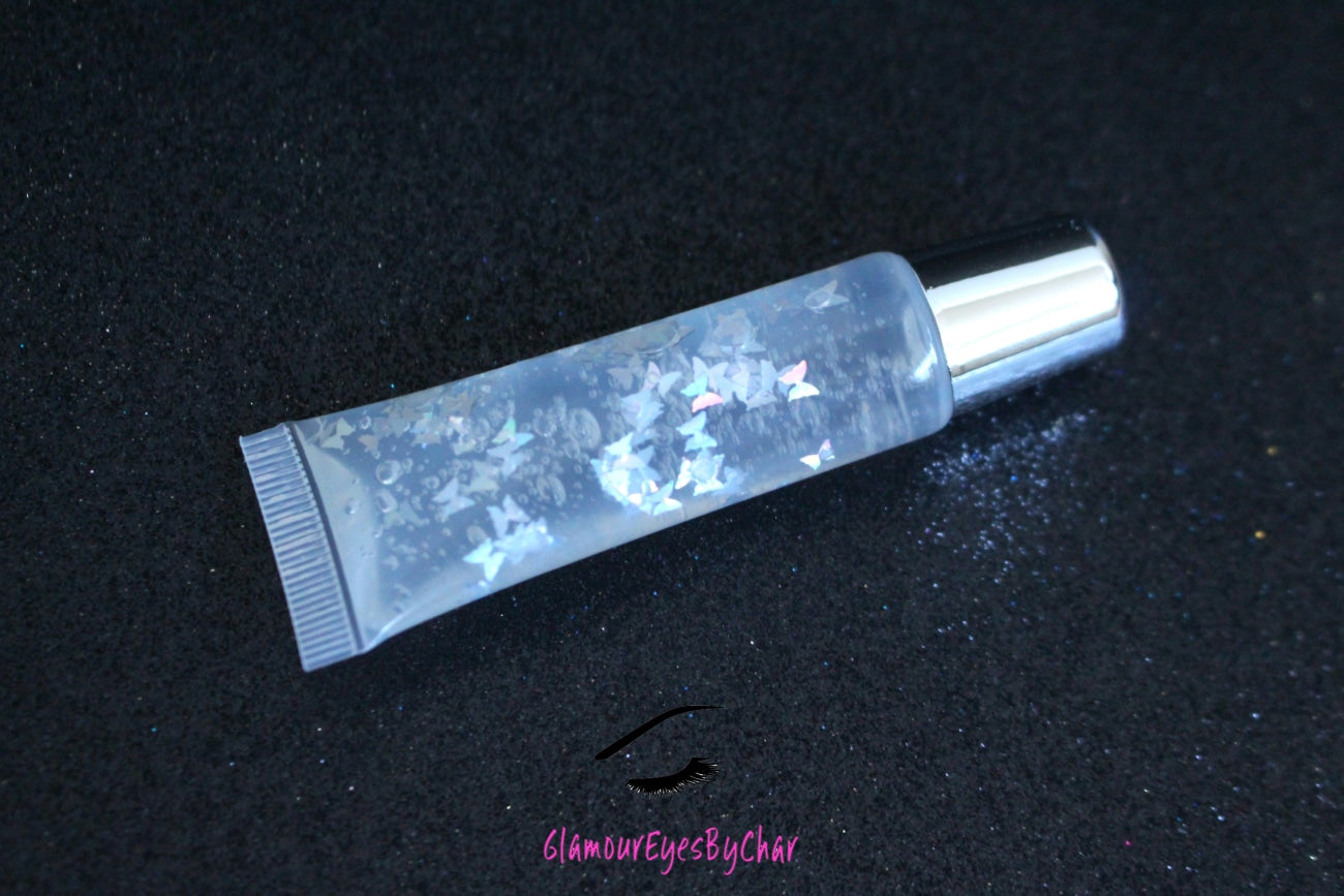 Crystal Clear is a clear handmade hydrating gloss with silver holographic butterflies. This gloss is also vegan, cruelty-free, gluten-free, high shine, smooth and long lasting. It's made with premium rich ingredients to keep your lips soft, moisturized and luscious without feeling sticky. Crystal Clear is available in a squeeze tube and a wand tube (flat doe foot applicator) for a more precise application.