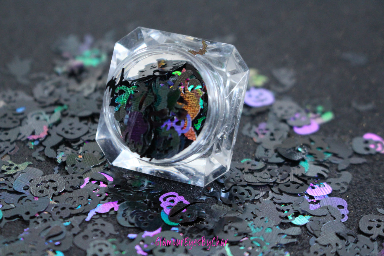 Halloween Mix – Premium Holographic Black Glitter Shapes
Get ready to haunt your look with this eerie blend from our Halloween Collection! Featuring spooky 8mm pumpkins and skulls, 10mm ghosts, 12mm black cats, 6mm bats, and towering 16mm witches, this holographic black mix is perfect for wickedly fun nail art and glitter slime.
Available in 5g jars only.