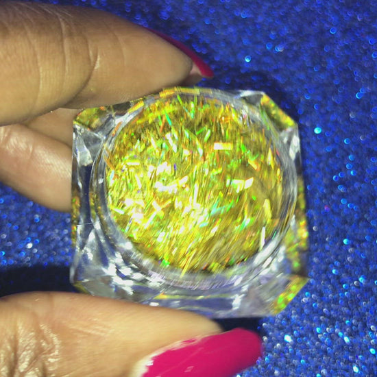 This glitter is called Holographic Gold Strips and is part of the shaped glitters collection. It consists of yellow gold strips with a holographic sparkle. Holographic Gold Strips can be used for your face, body, hair and nails.