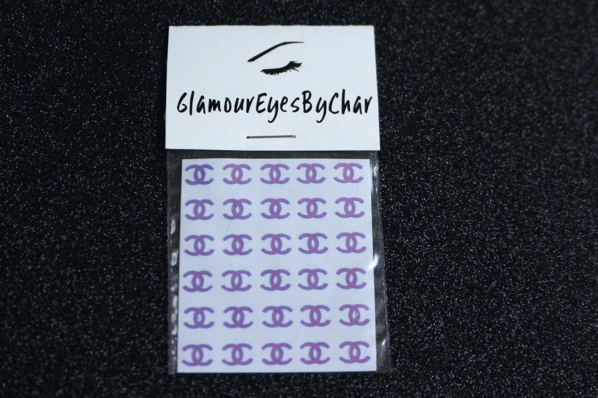 Chanel Inspired Nail Stickers – 30 Pieces (5 Colours)
No need to visit the nail salon—spice up your nails at home with these elegant Chanel designer-inspired nail stickers. Perfect for natural or acrylic nails, you can apply them over regular polish, gel, or shellac. 
Handmade with care, these stickers are great for creating chic nail art or adding flair to fun DIY projects.
🌟 Glam Tip: Apply some of our glitter on your nails to really GLAMOUREYES your look.
