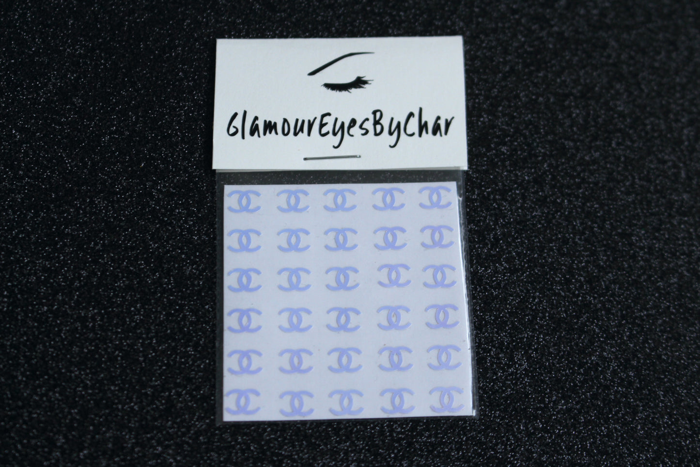 No need to go to the nail salon. Spice up your nails at home with these unique Chanel designer inspired nail decals. They can be used on natural or acrylic nails. You can also easily apply them on top of regular or gel/shellac nail polish. These handmade decals can also be used for body art or any DIY project. Each pack contains 30 decals and is available in 4 different colours.