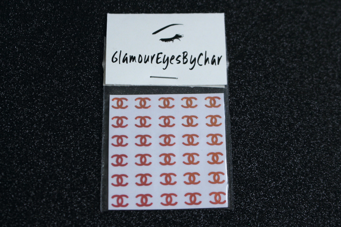 No need to go to the nail salon. Spice up your nails at home with these unique Chanel designer inspired nail decals. They can be used on natural or acrylic nails. You can also easily apply them on top of regular or gel/shellac nail polish. These handmade decals can also be used for body art or any DIY project. Each pack contains 30 decals and is available in 4 different colours.