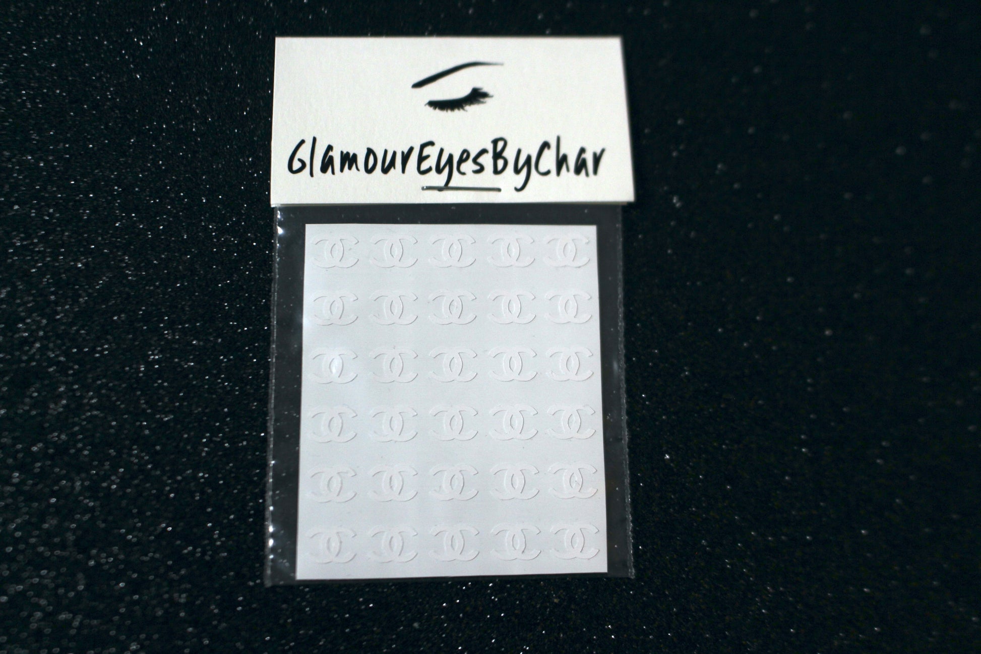 Chanel Inspired Nail Stickers – 30 Pieces (5 Colours)
No need to visit the nail salon—spice up your nails at home with these elegant Chanel designer-inspired nail stickers. Perfect for natural or acrylic nails, you can apply them over regular polish, gel, or shellac. 
Handmade with care, these stickers are great for creating chic nail art or adding flair to fun DIY projects.
🌟 Glam Tip: Apply some of our glitter on your nails to really GLAMOUREYES your look.
