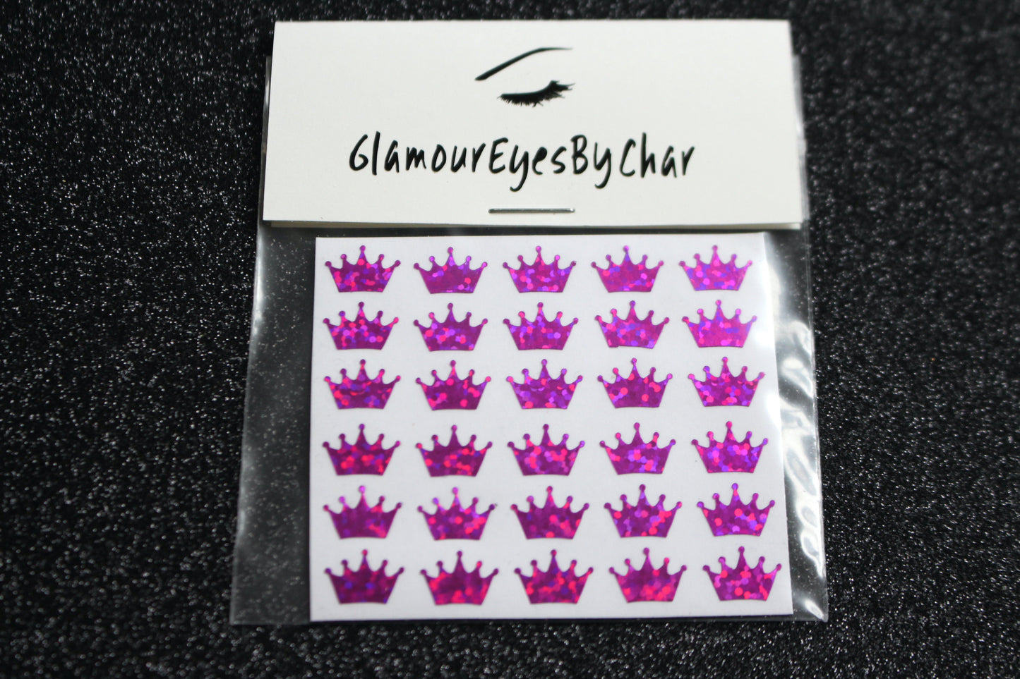 No need to go to the nail salon. Spice up your nails at home with these cute crown nail decals. They can be used on natural or acrylic nails. You can also apply them on top of regular or gel/shellac nail polish. These handmade decals can also be used for body art or any DIY project. Each pack contains 30 decals and is available in 6 different colours. Tip: Apply some of our glitter on your nails to really GLAMOUREYES your look.