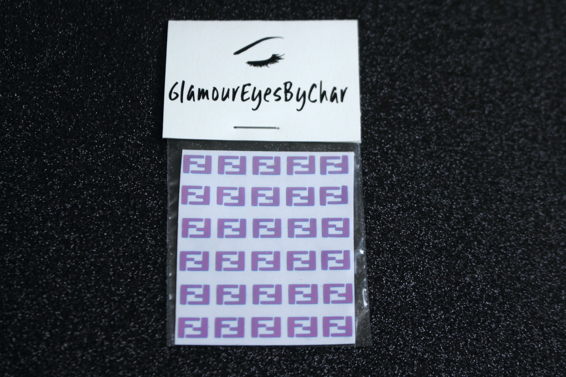 Spice up your nails with these unique FF designer inspired nail decals. They can be used on natural or acrylic nails. You can also apply them on top of regular or gel/shellac nail polish. These handmade decals can also be used for body art or any DIY project. The pack contains 30 decals and is available in 4 different colours.   Size: W= 0.3 inches, H= 0.22 inches  Tip: Apply some of our glitter on your nails to really GLAMOUREYES your look.