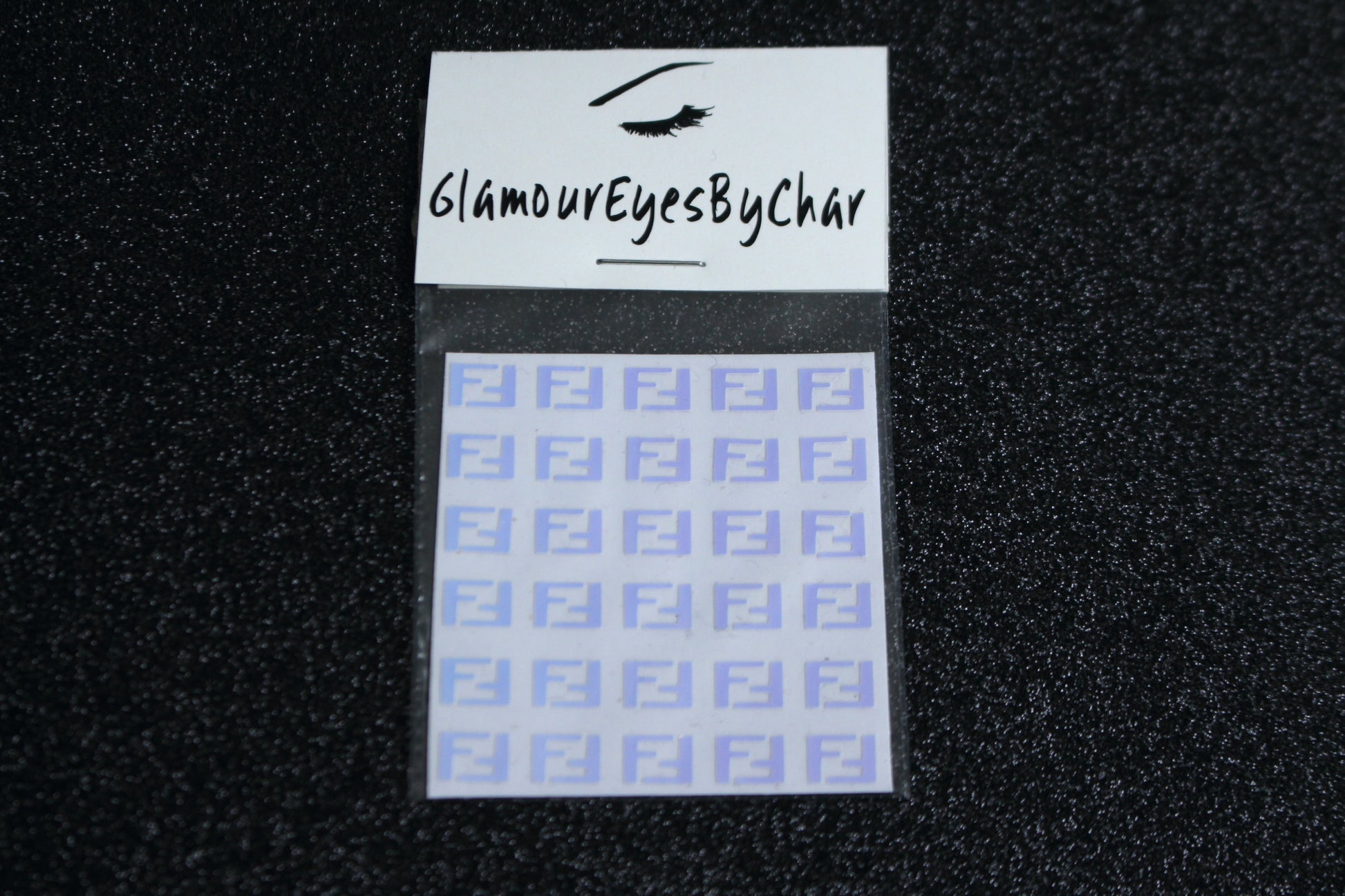 Spice up your nails with these unique FF designer inspired nail decals. They can be used on natural or acrylic nails. You can also apply them on top of regular or gel/shellac nail polish. These handmade decals can also be used for body art or any DIY project. The pack contains 30 decals and is available in 4 different colours.   Size: W= 0.3 inches, H= 0.22 inches  Tip: Apply some of our glitter on your nails to really GLAMOUREYES your look.