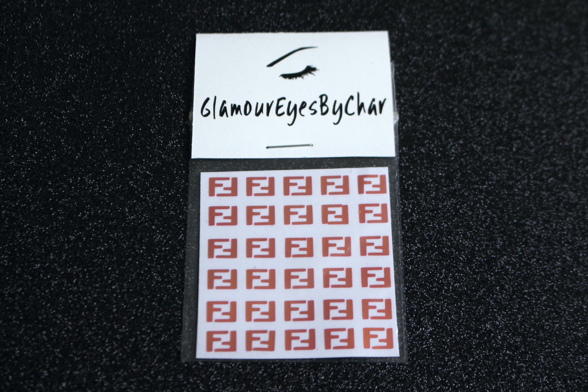 Spice up your nails with these unique FF designer inspired nail decals. They can be used on natural or acrylic nails. You can also apply them on top of regular or gel/shellac nail polish. These handmade decals can also be used for body art or any DIY project. The pack contains 30 decals and is available in 4 different colours.   Size: W= 0.3 inches, H= 0.22 inches  Tip: Apply some of our glitter on your nails to really GLAMOUREYES your look.