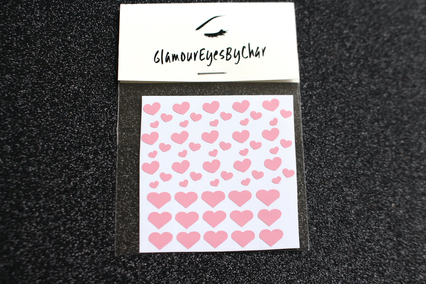 No need to go to the nail salon. Spice up your nails at home with these cute heart nail decals. They can be used on natural or acrylic nails. You can also apply them on top of regular or gel/shellac nail polish. These handmade decals can also be used for body art or any DIY project. Each pack contains 60 decals and is available in 4 different colours. The pack also includes 4 different sizes so that you can mix and match. Tip: Apply some of our glitter on your nails to really GLAMOUREYES your look.