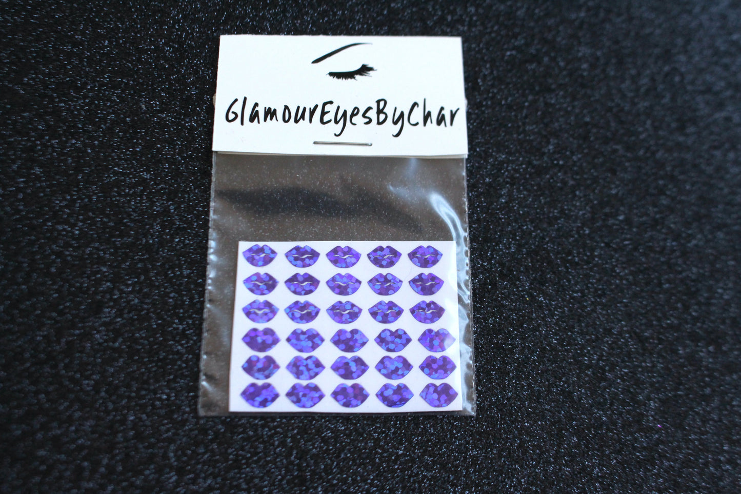 Spice up your nails with these cute lips nail decals. They can be used on natural or acrylic nails. You can also apply them on top of regular or gel/shellac nail polish. These handmade decals can also be used for body art or any DIY project. Each pack contains 30 decals and is available in 3 different colours. Tip: Apply some of our glitter on your nails to really GLAMOUREYES your look.