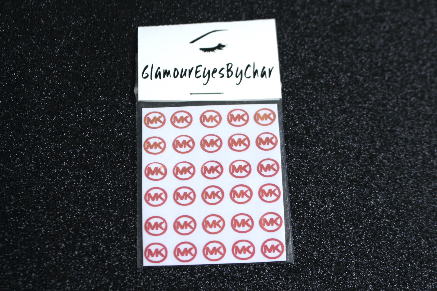 No need to go to the nail salon. Spice up your nails at home with these unique Michael Kors designer inspired nail stickers. They can be used on natural or acrylic nails. You can easily also apply them on top of regular or gel/shellac nail polish. These handmade stickers can also be used for body art or any DIY project. Each pack contains 30 stickers and is available in 5 different colours.  Tip: Apply some of our glitter on your nails to really GLAMOUREYES your look.