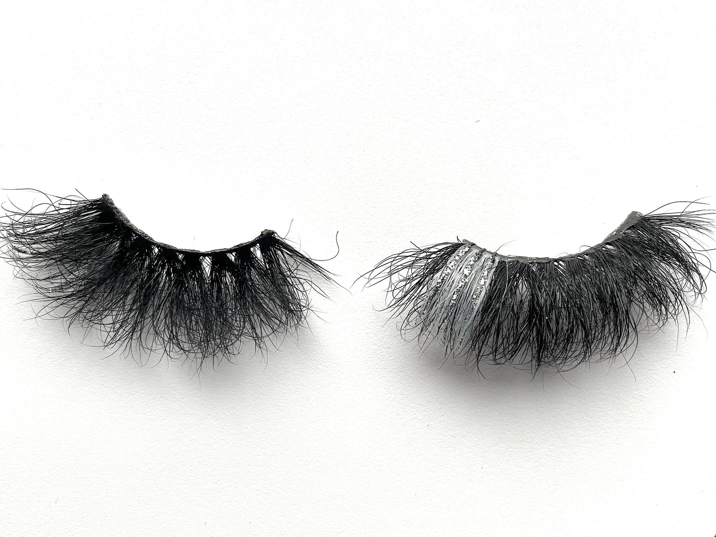 Stormy – 5D Premium Mink Lashes (25mm)
These 5D premium mink lashes are 25mm in length—dramatic, fluffy, lightweight, and comfortable to wear. A pop of silver and glitter on the outer corners adds extra sparkle and playfulness to your eyes. The flexible cotton lash band makes application a breeze.
Stormy lashes are designed to stand out at any event ⚡. They’re bold, eye-catching, and not for timid lash wearers. Each reusable pair can be worn up to 25 times with proper care.