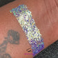This glitter is called Grapetini and is part of the cellophane glitter flakes collection. It consists of purple iridescent glitter shards with green and golden reflects. Grapetini is perfect for body and nail art, glitter slime, resin art or DIY projects. Comes in 5g jars only.  