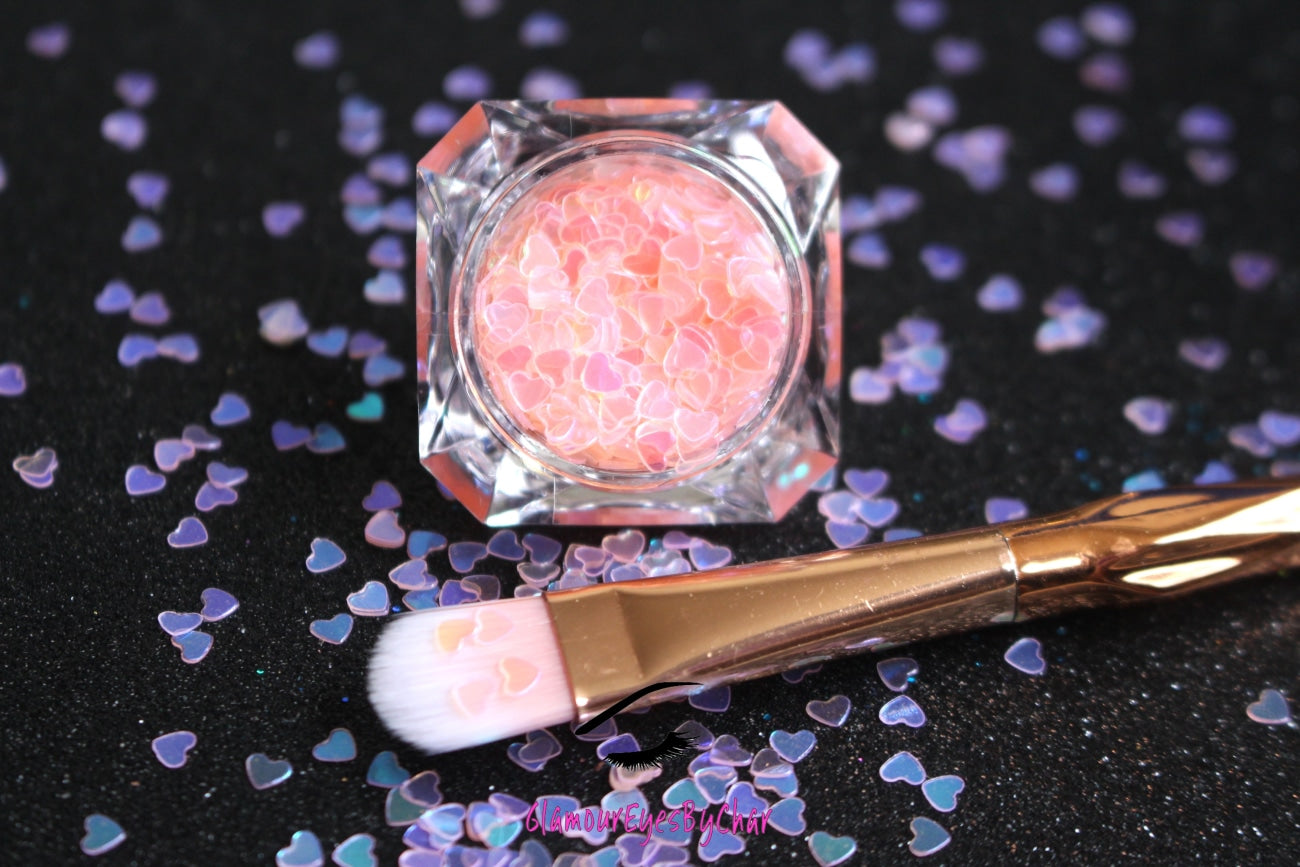This glitter is called Baby Pink Hearts and is part of the shaped glitters collection. It consists of baby pink hearts with an iridescent sparkle. Baby Pink Hearts is perfect for  body and nail art or DIY projects.  Comes in 5g jars only.