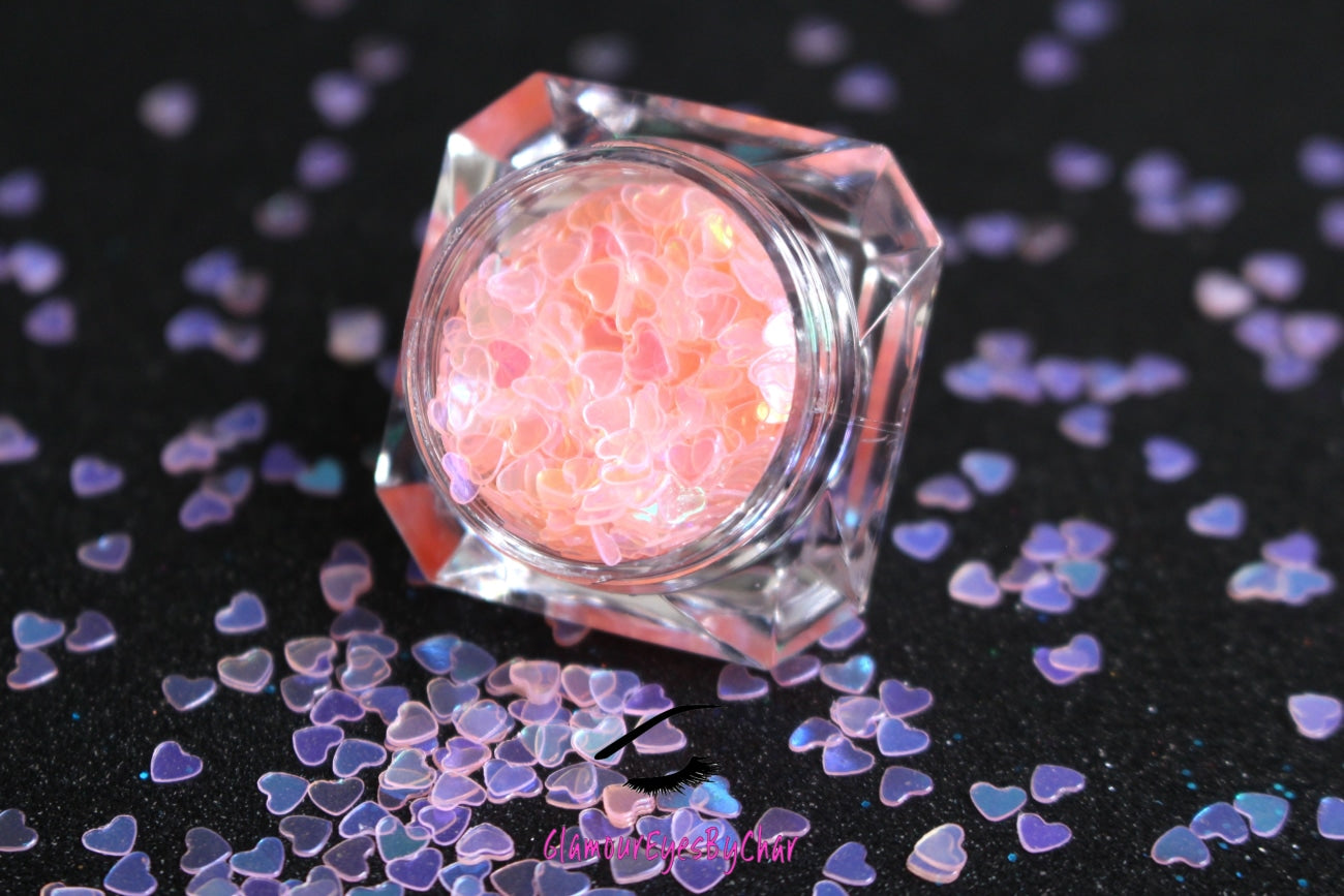 This glitter is called Baby Pink Hearts and is part of the shaped glitters collection. It consists of baby pink hearts with an iridescent sparkle. Baby Pink Hearts is perfect for  body and nail art or DIY projects.  Comes in 5g jars only.