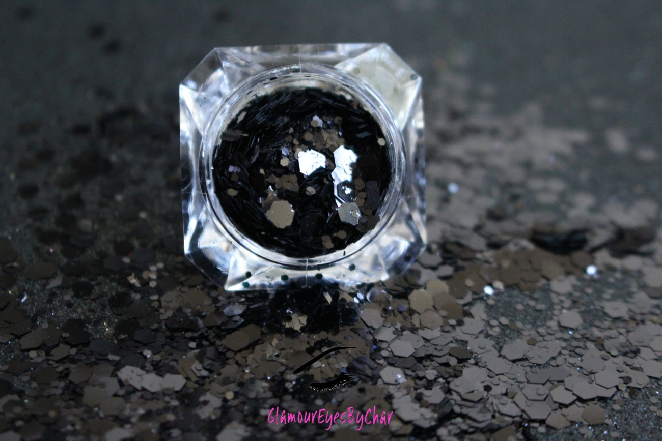 This glitter is called Black Out and is part of the super chunky glitter collection. It consists of solid jet black glitter. If you'd like a little more sparkle, it also comes in black holographic glitter. Black Out can be used for your face, body, hair and nails. Comes in 5g jars only.