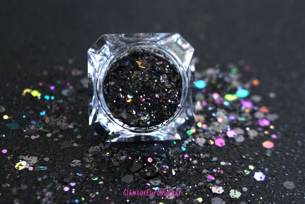 This glitter is called Black Out and is part of the super chunky glitter collection. It consists of solid jet black glitter. If you'd like a little more sparkle, it also comes in black holographic glitter. Black Out can be used for your face, body, hair and nails. Comes in 5g jars only.