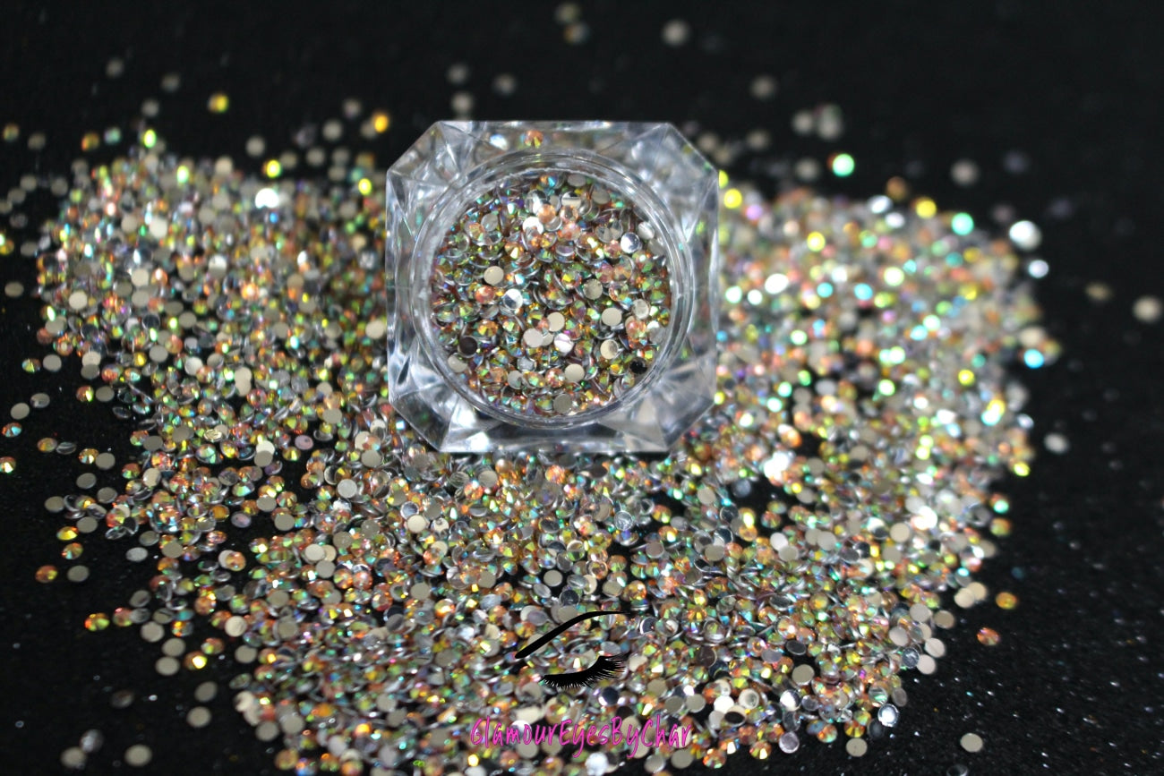 Spice up your nails or makeup look with these champagne AB flatback resin rhinestones. Stone size: 2mm and 3mm Available in 5g and 10g jars. Note: 10g jars are round and not diamond shaped. Rhinestones are not counted individually and go by the weight of the jar.