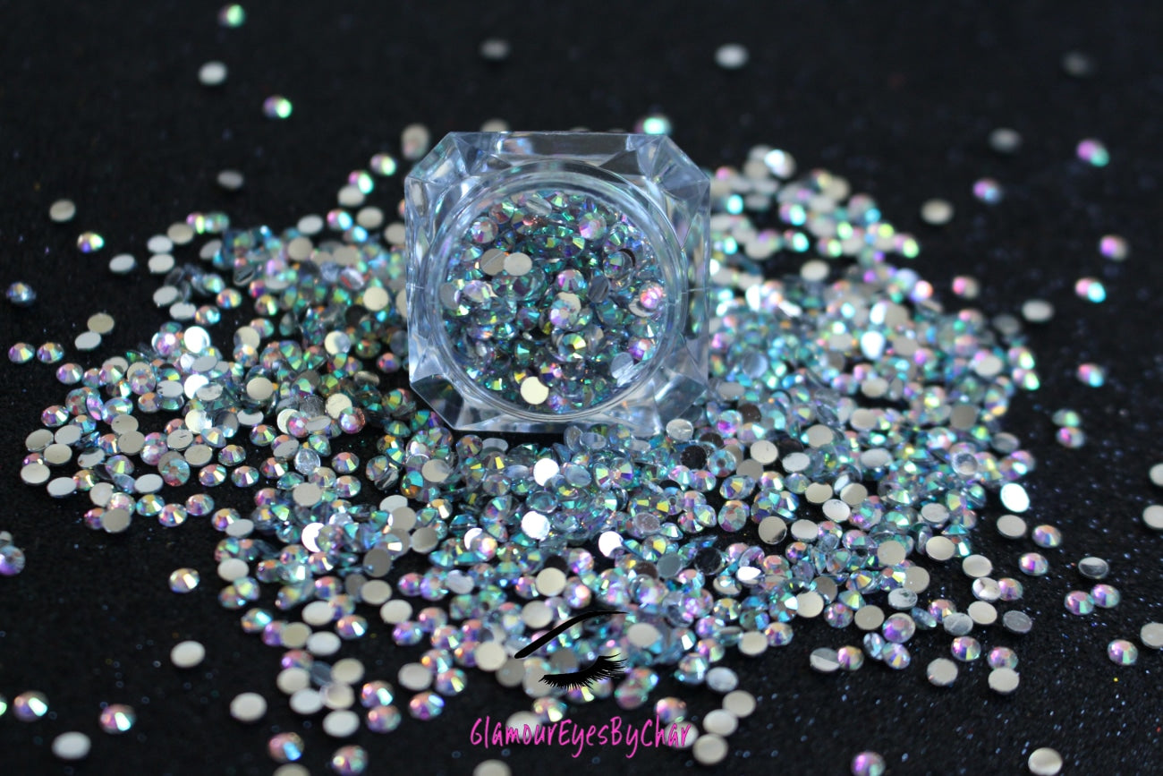 Spice up your nails or makeup look with these clear AB flatback resin rhinestones.  Stone size: 2mm and 3mm Available in 5g and 10g jars.  Note: 10g jars are round and not diamond shaped. Rhinestones are not counted individually and go by the weight of the jar.  Tip#1:  Apply rhinestones with our crystal dual-ended rhinestone picker. The application process will be made quick and easy.