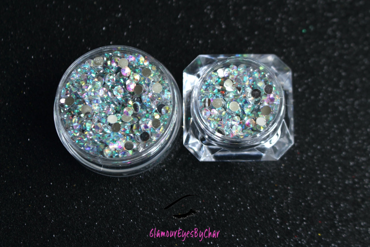 Spice up your nails or makeup look with these clear AB flatback resin rhinestones.  Stone size: 2mm and 3mm Available in 5g and 10g jars.  Note: 10g jars are round and not diamond shaped. Rhinestones are not counted individually and go by the weight of the jar.  Tip#1:  Apply rhinestones with our crystal dual-ended rhinestone picker. The application process will be made quick and easy.