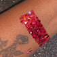 This glitter is called Santa Baby and is part of the super chunky glitter collection. It consists of ruby red glitter with a holographic sparkle. Santa Baby can be used for your face, body, hair and nails. Available in 5g jars only.