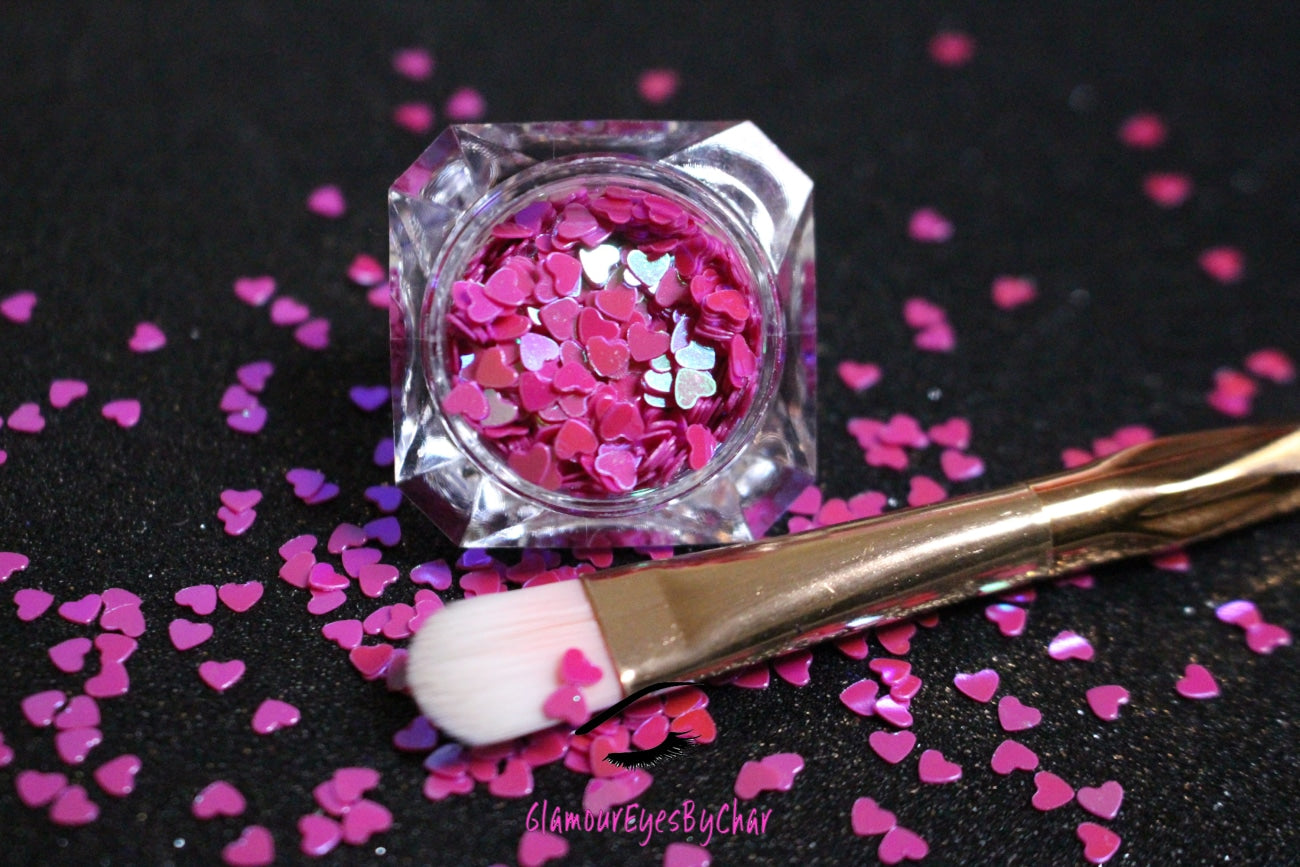 This glitter is called Dark Pink Hearts and is part of the shaped glitters collection. It consists of dark pink hearts with an iridescent sparkle. Dark Pink Hearts is perfect for body and nail art or DIY projects. Comes in 5g jars only.