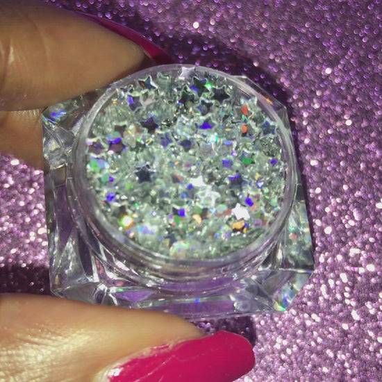 This glitter is called Holographic Silver Stars and is part of the shaped glitters collection. It consists of silver small stars with a holographic sparkle. Holographic Silver Stars can be used for your face, body, hair and nails.