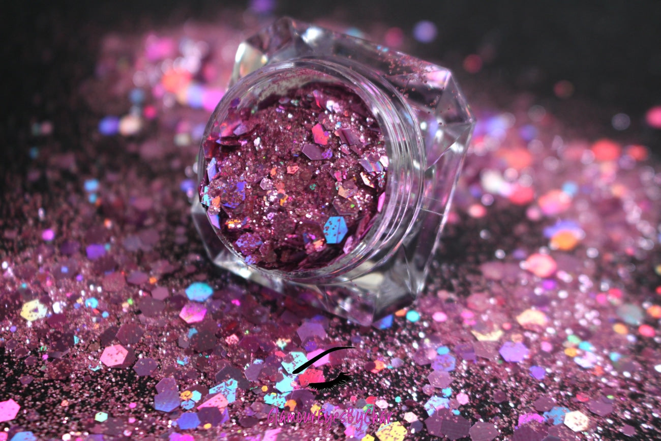 This glitter is called Girl Power and is part of the super chunky glitter collection. It consists of pink and light purple glitter with a holographic sparkle. Girl Power can be used for your face, body, hair and nails. Comes in 5g jars only.