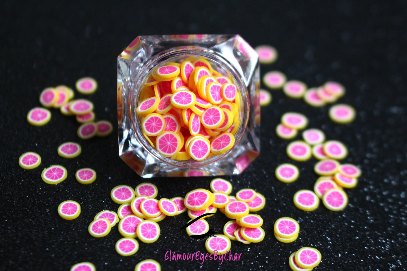 These Grapefruit Fruit Slices are PERFECT for 3D nail or body art. They can also be used for a DIY craft project. The fruit slices are made of polymer clay and are approximately 3mm/0.12 inch in size. Comes in 5g jars only. Note: Grapefruit Fruit Slices are not recommended for use in the immediate eye area. Tip: Apply some of our glitter to your nails to really GLAMOUREYES your look.