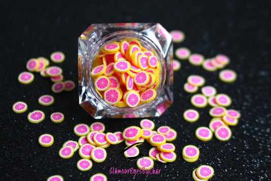 These Grapefruit Fruit Slices are PERFECT for 3D nail or body art. They can also be used for a DIY craft project. The fruit slices are made of polymer clay and are approximately 3mm/0.12 inch in size. Comes in 5g jars only. Note: Grapefruit Fruit Slices are not recommended for use in the immediate eye area. Tip: Apply some of our glitter to your nails to really GLAMOUREYES your look.