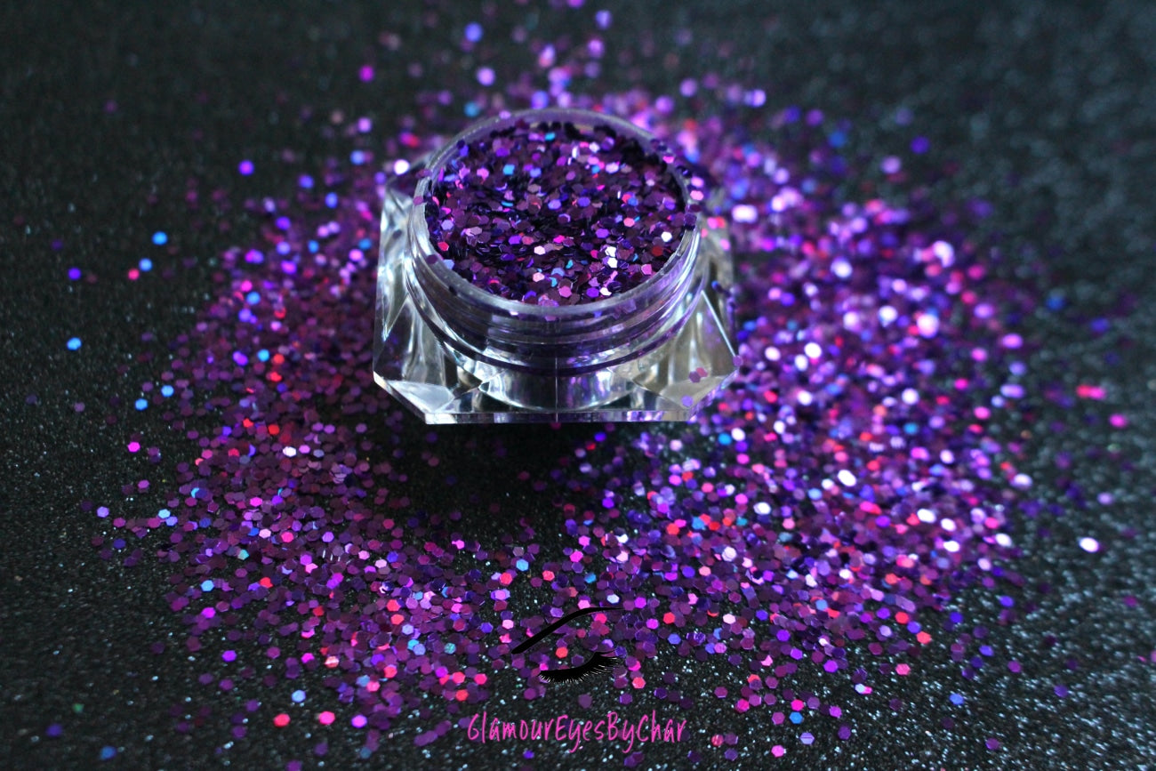 This glitter is called Grapesicle and is part of the simple glitter collection. It consists of dark violet glitter with a holographic sparkle. Flake size is larger than fine and extra fine glitter. Grapesicle can be used for your face, body, hair and nails. Comes in 5g jars only.