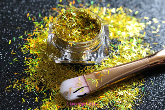 This glitter is called Holographic Gold Strips and is part of the shaped glitters collection. It consists of yellow gold strips with a holographic sparkle. Holographic Gold Strips can be used for your face, body, hair and nails.