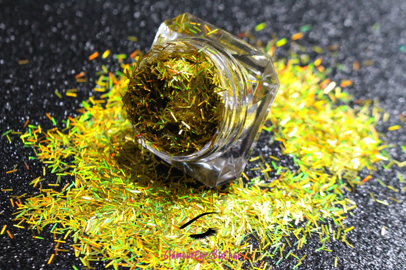 This glitter is called Holographic Gold Strips and is part of the shaped glitters collection. It consists of yellow gold strips with a holographic sparkle. Holographic Gold Strips can be used for your face, body, hair and nails.