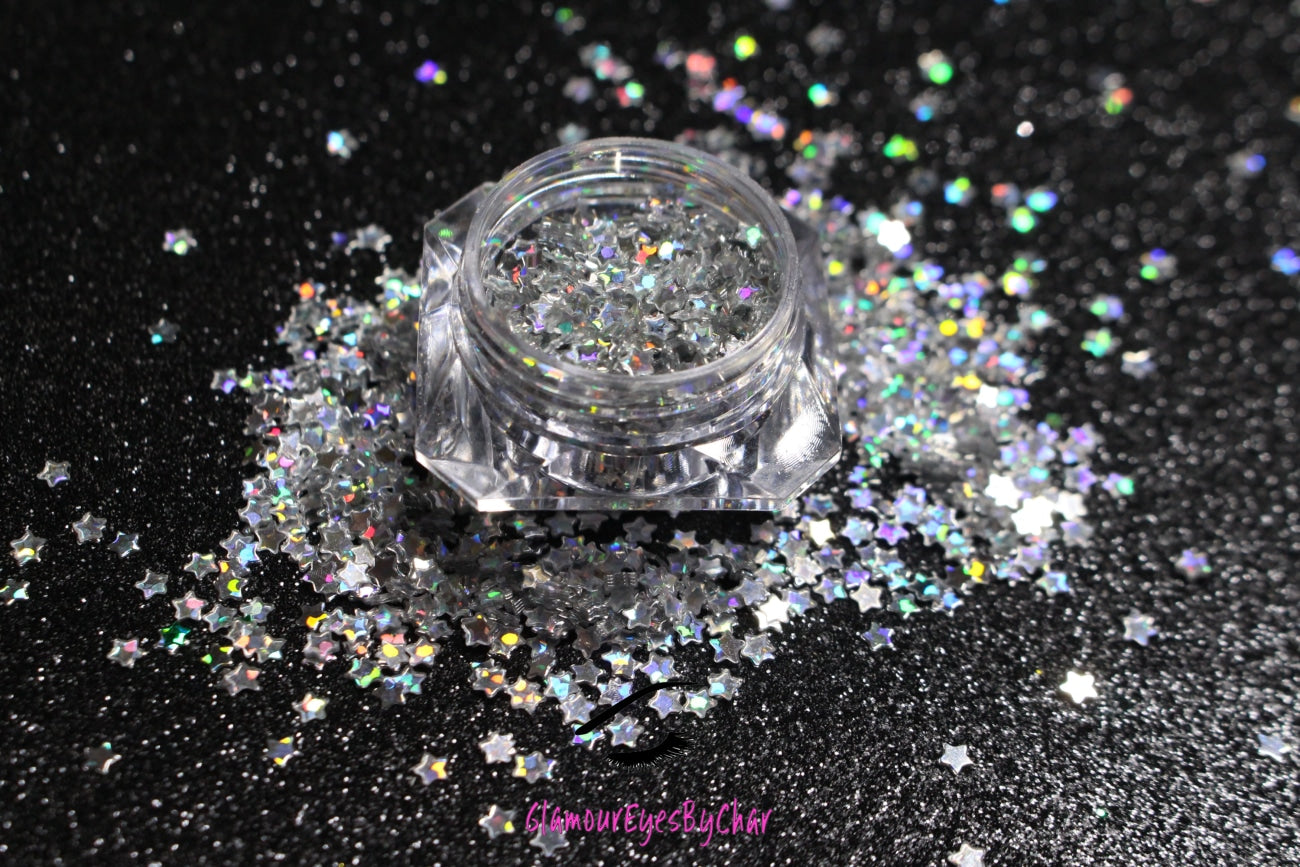 This glitter is called Holographic Silver Stars and is part of the shaped glitters collection. It consists of silver small stars with a holographic sparkle. Holographic Silver Stars can be used for your face, body, hair and nails.