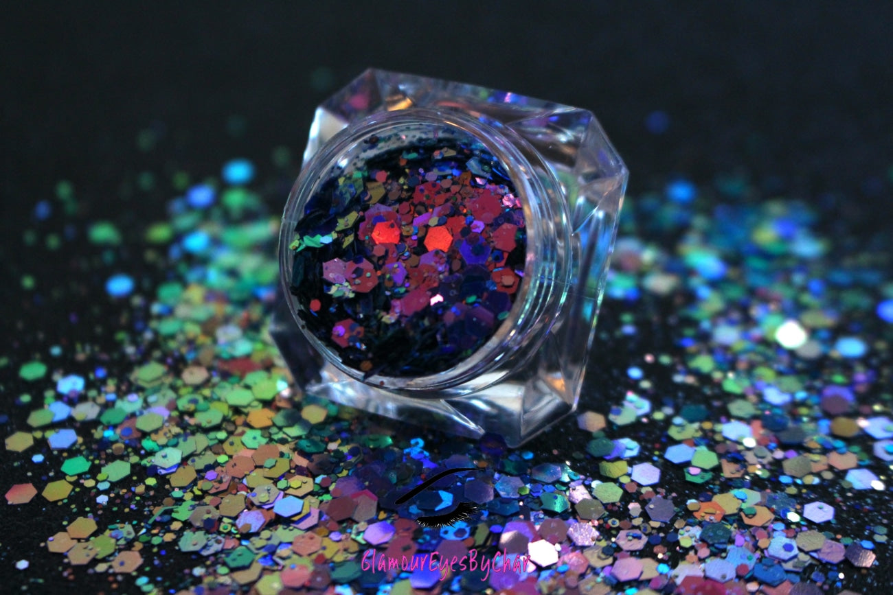 This chameleon glitter is called Hypnotic and is part of the super chunky glitter collection. It consists of dark pink glitter with a purple and teal unique colour shifting sparkle. Hypnotic can be used for your face, body, hair and nails.  Comes in 5g jars only.