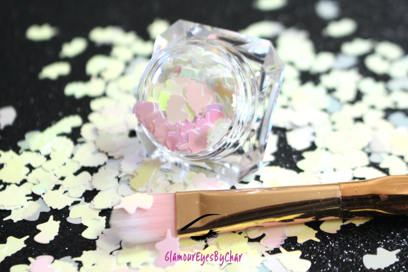 This glitter is called Iridescent Unicorns and is part of the shaped glitters collection. It consists of white iridescent 6.0mm unicorns. Iridescent Unicorns is perfect for nail and body art. Comes in 5g jars only.