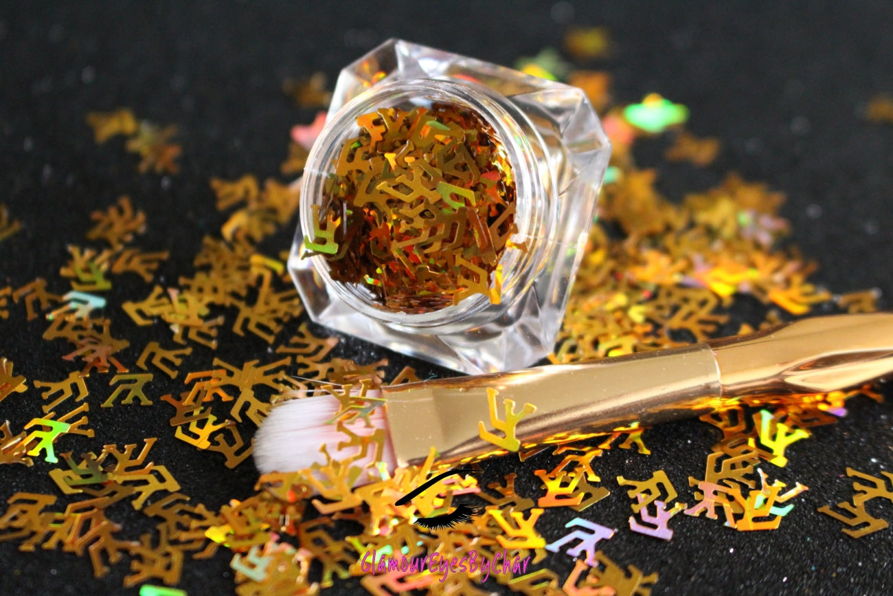 This glitter is called LV and is part of the shaped glitters collection. It consists of unique Louis Vuitton designer inspired holographic gold LV letters. LV can be used for body and nail art or DIY projects. Available in 5g jars only.