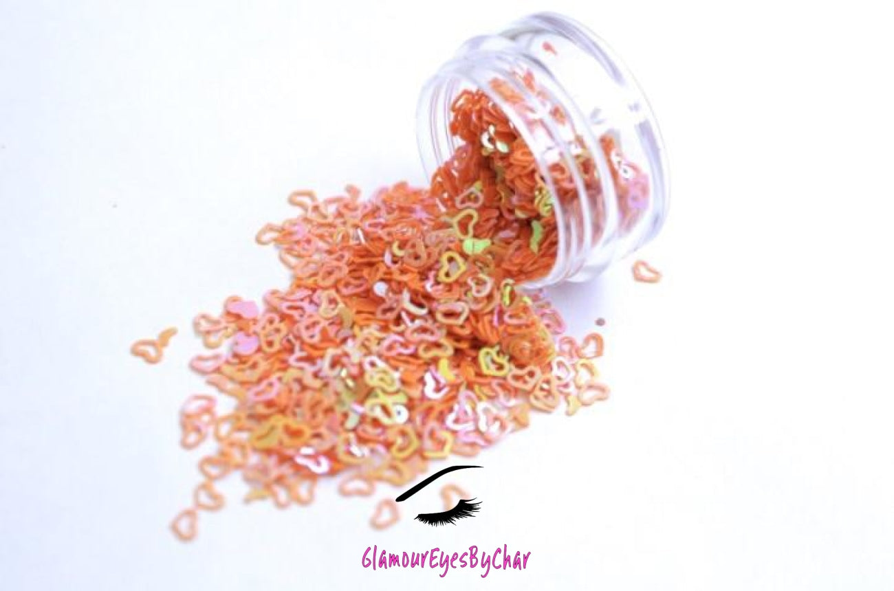 This glitter is called Orange Hearts and is part of the shaped glitters collection. It consists of orange small and large hearts with an iridescent sparkle. Orange Hearts is perfect for body and nail art or DIY projects. Comes in 5g jars only. **Glitter will be discontinued once sold out**
