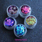 The Party Girl stacker is comprised of glitters from the super chunky collection. These glitters are perfect for an eye catching look for a night out on the town. The glitters in this set are as follows: Daydream Fantasy Mardi Gras Deep Sea Hypnotic   The Party Girl stacker can be used for your face, body, hair and nails. Available in 5g jars only. 