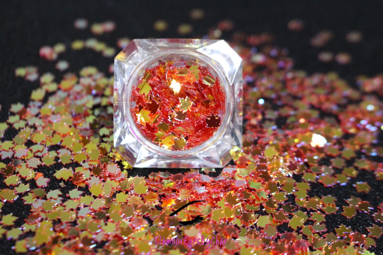 This glitter is called Warm Gold Maple Leafs and is part of the shaped glitters collection. It consists of warm red orange 4.0mm maple leafs with a gold sparkle. Warm Gold Maple Leafs is perfect for body and nail art or DIY projects. Comes in 5g jars only.