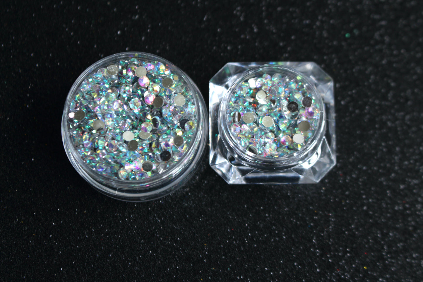 Clear AB Rhinestones – Flatback Resin (2mm &amp; 3mm)
Part of our Glamour Goodies Collection, these clear AB flatback resin rhinestones are perfect for adding extra sparkle to your nails or any creative project. With a brilliant shimmer that catches the light, they bring just the right touch of glam wherever you use them.

Stone size: 2mm and 3mm
Available in 5g and 10g jars.
Note: 10g jars are round and not diamond shaped. Rhinestones are sold by weight and not individually counted.