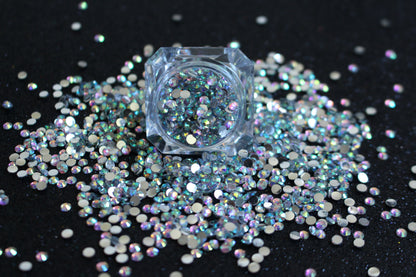 Clear AB Rhinestones – Flatback Resin (2mm &amp; 3mm)
Part of our Glamour Goodies Collection, these clear AB flatback resin rhinestones are perfect for adding extra sparkle to your nails or any creative project. With a brilliant shimmer that catches the light, they bring just the right touch of glam wherever you use them.

Stone size: 2mm and 3mm
Available in 5g and 10g jars.
Note: 10g jars are round and not diamond shaped. Rhinestones are sold by weight and not individually counted.