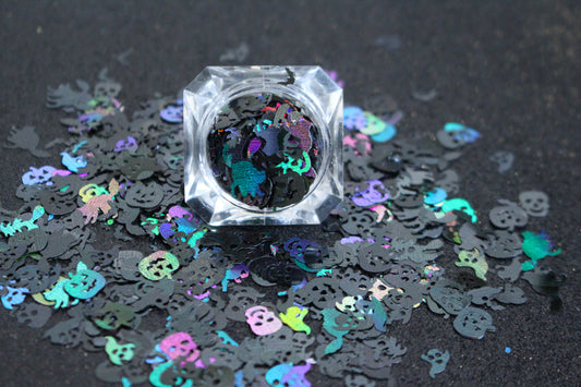 Halloween Mix – Premium Holographic Black Glitter Shapes
Get ready to haunt your look with this eerie blend from our Halloween Collection! Featuring spooky 8mm pumpkins and skulls, 10mm ghosts, 12mm black cats, 6mm bats, and towering 16mm witches, this holographic black mix is perfect for wickedly fun nail art and glitter slime.
Available in 5g jars only.