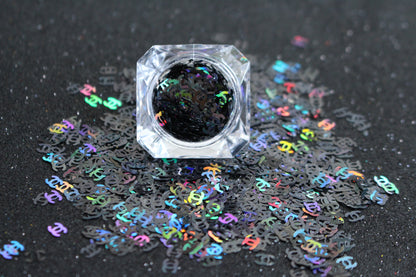 CC Glitter – Premium Chanel-Inspired Holographic Black Letters
Part of our Shaped Glitter Collection, these unique holographic black CC letters add a touch of designer-inspired glam to your nail art and glitter slime.
Available in 5g jars only.