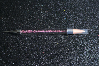 




Crystal Rhinestone Picker – Dual-Ended Tool for Nail Art &amp; DIY
Part of our Glamour Goodies Collection, this crystal dual-ended rhinestone picker is a must-have tool for effortlessly applying rhinestones and beads to nail art or creative DIY projects.

The detachable wax tip helps you easily pick up and place gems, while the stainless steel tip provides precision for more detailed work. Whether you’re working on intricate nail art or creative DIY projects, this tool makes the application process smo