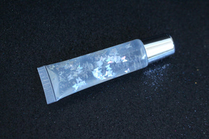 Crystal Clear is a clear handmade hydrating gloss with silver holographic butterflies. This gloss is also vegan, cruelty-free, gluten-free, high shine, smooth and long lasting. It's made with premium rich ingredients to keep your lips soft, moisturized and luscious without feeling sticky. Crystal Clear is available in a squeeze tube and a wand tube (flat doe foot applicator) for a more precise application.