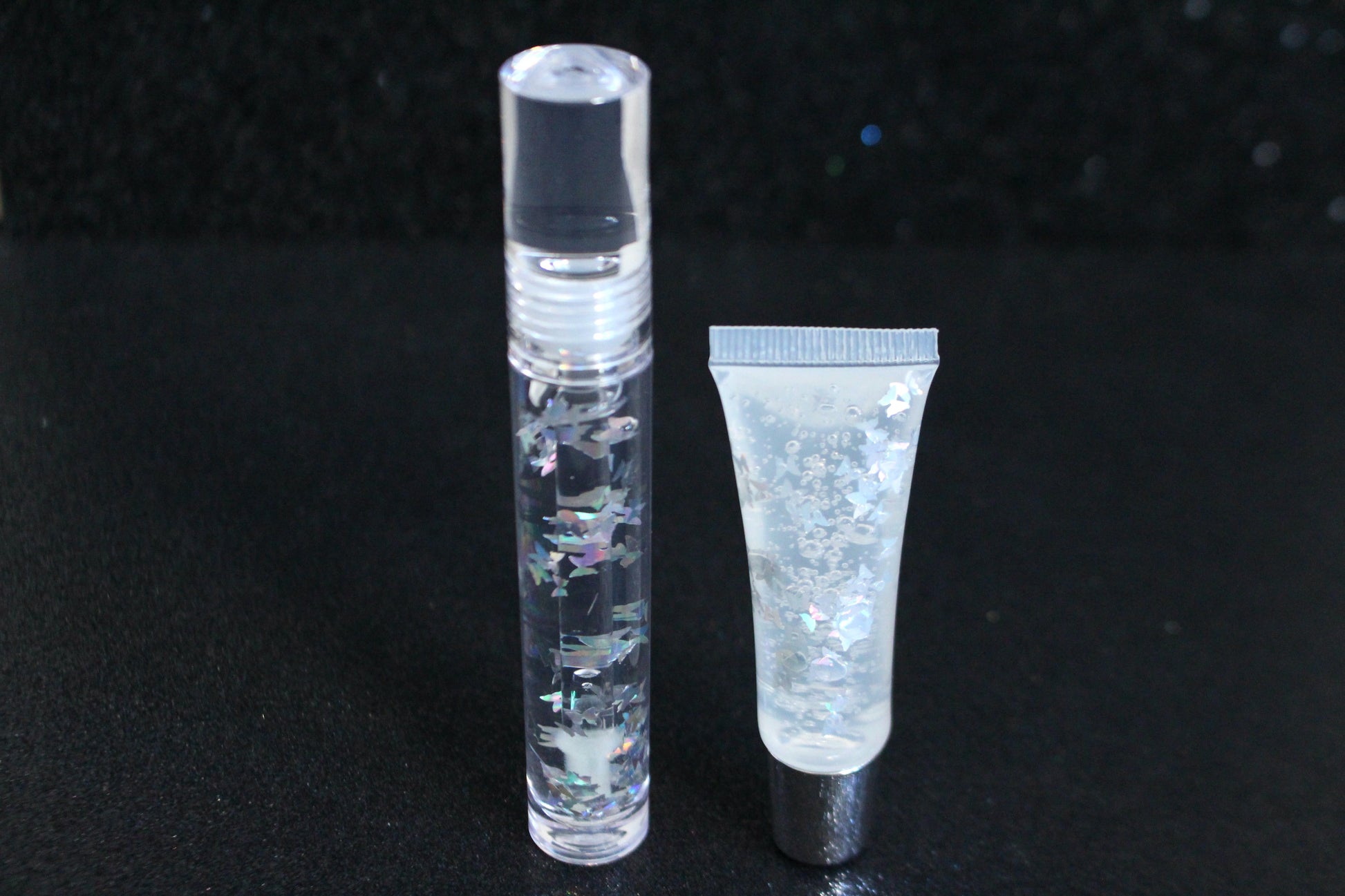 Crystal Clear is a clear handmade hydrating gloss with silver holographic butterflies. This gloss is also vegan, cruelty-free, gluten-free, high shine, smooth and long lasting. It's made with premium rich ingredients to keep your lips soft, moisturized and luscious without feeling sticky. Crystal Clear is available in a squeeze tube and a wand tube (flat doe foot applicator) for a more precise application.
