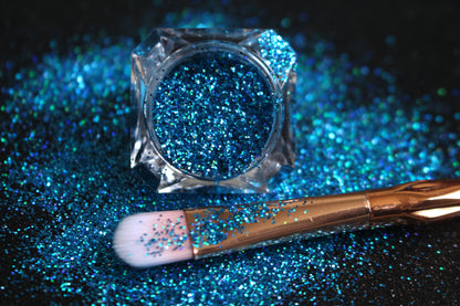This glitter is called Poolside and is part of the simple glitter collection. It consists of caribbean sea blue glitter with a holographic sparkle.  Poolside can be used for your face, body, hair and nails. Comes in 5g jars only.