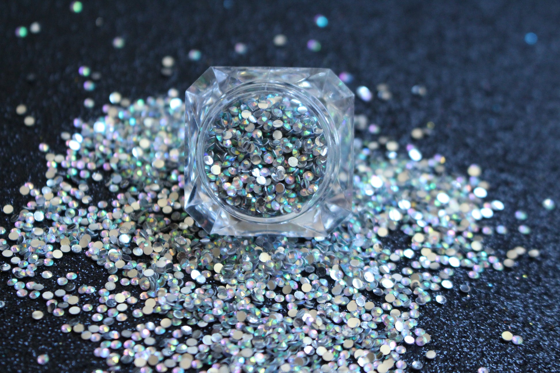Clear AB Rhinestones – Flatback Resin (2mm &amp; 3mm)
Part of our Glamour Goodies Collection, these clear AB flatback resin rhinestones are perfect for adding extra sparkle to your nails or any creative project. With a brilliant shimmer that catches the light, they bring just the right touch of glam wherever you use them.

Stone size: 2mm and 3mm
Available in 5g and 10g jars.
Note: 10g jars are round and not diamond shaped. Rhinestones are sold by weight and not individually counted.