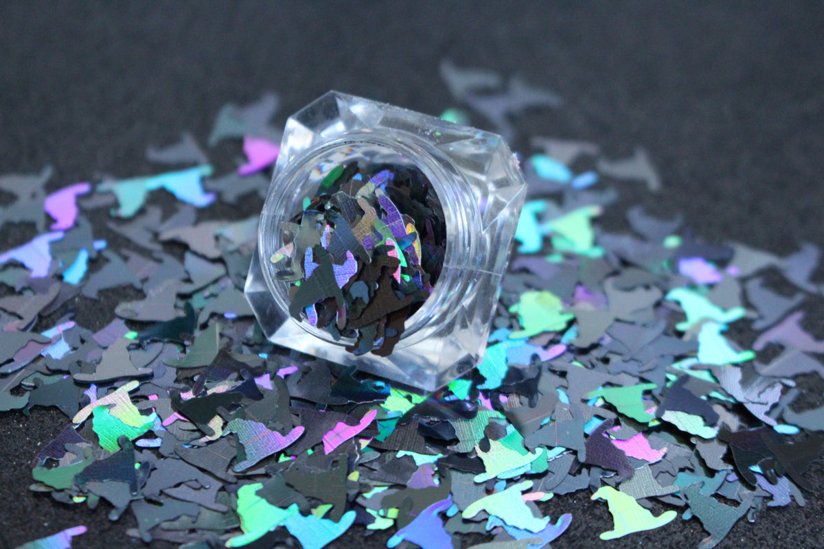 Witch Hats – Premium 10mm Holographic Black Glitter Shapes
Part of our Halloween Collection, these bold 10mm witch hat shapes add a magical, spooky touch to your nail art and glitter slime this season!
Available in 5g jars only.